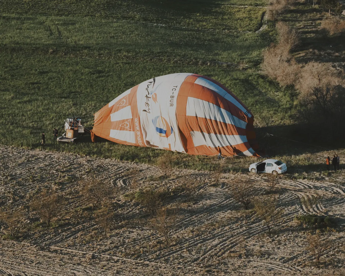 Hot air balloon laid out in a field after landing