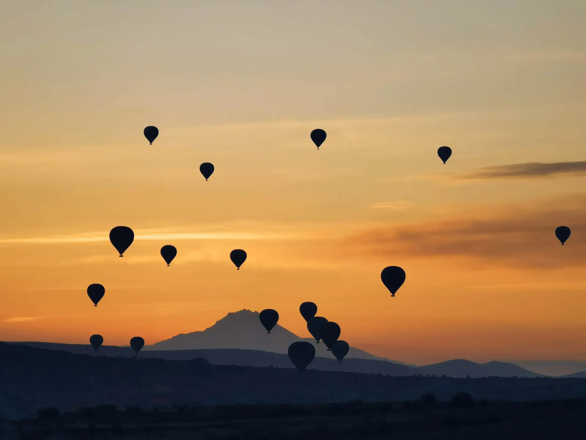 Montgolfières au-dessus des montagnes au crépuscule